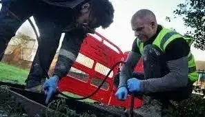 Professional conducting CCTV inspection of drainage pipes with advanced technology