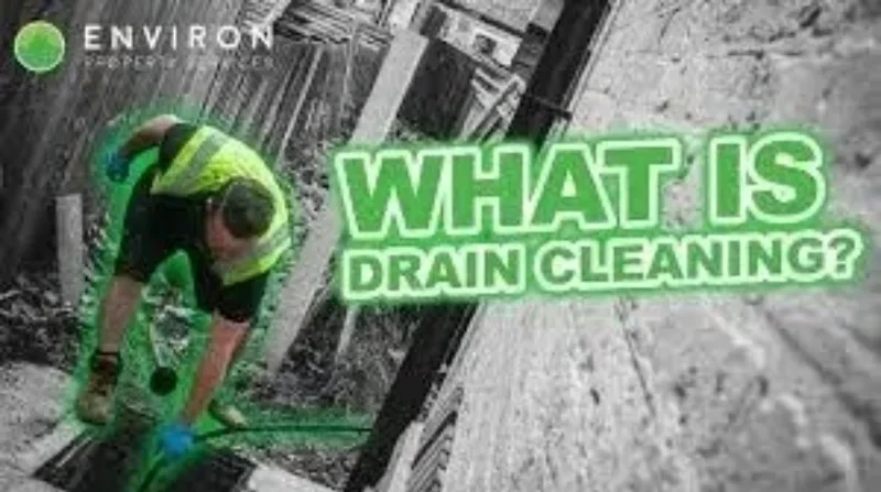 Professional drainage contractor inspecting a drainage system in a residential area, showcasing compliance and safety